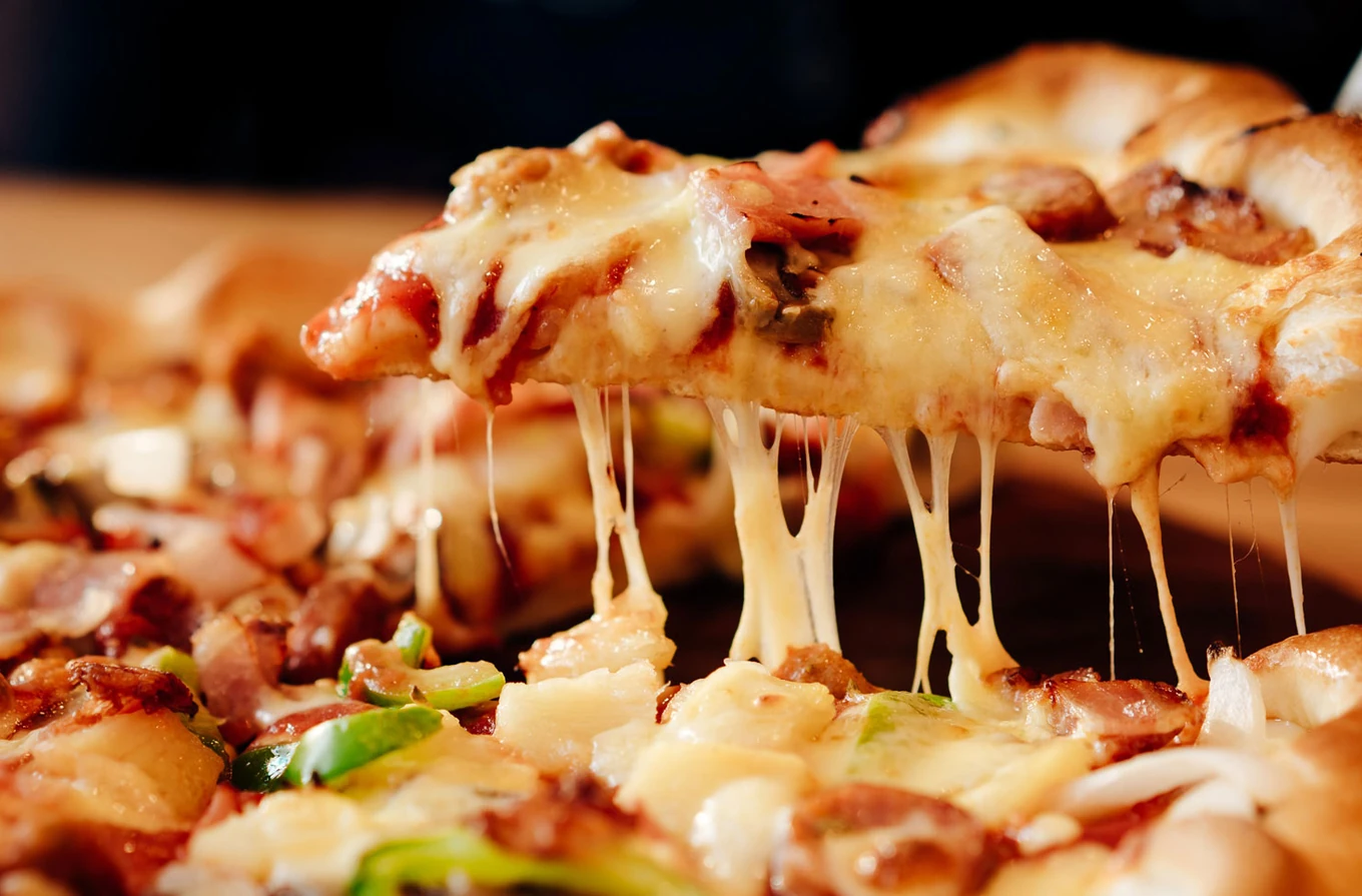 Cheese pull from a fresh hand-built pizza at Monty's Pizza in Lewis Estates, Edmonton