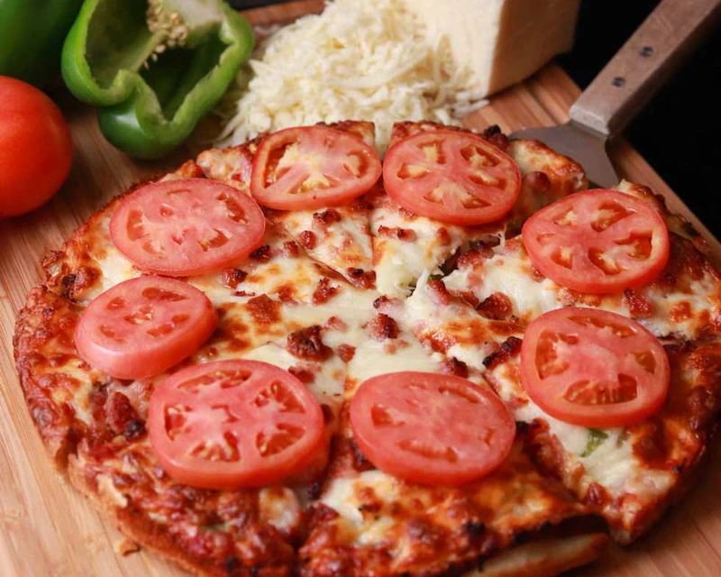 Monty Deluxe pizza with beef, ham, bacon, onion, green pepper and tomato at Monty's Pizza in Edmonton, AB