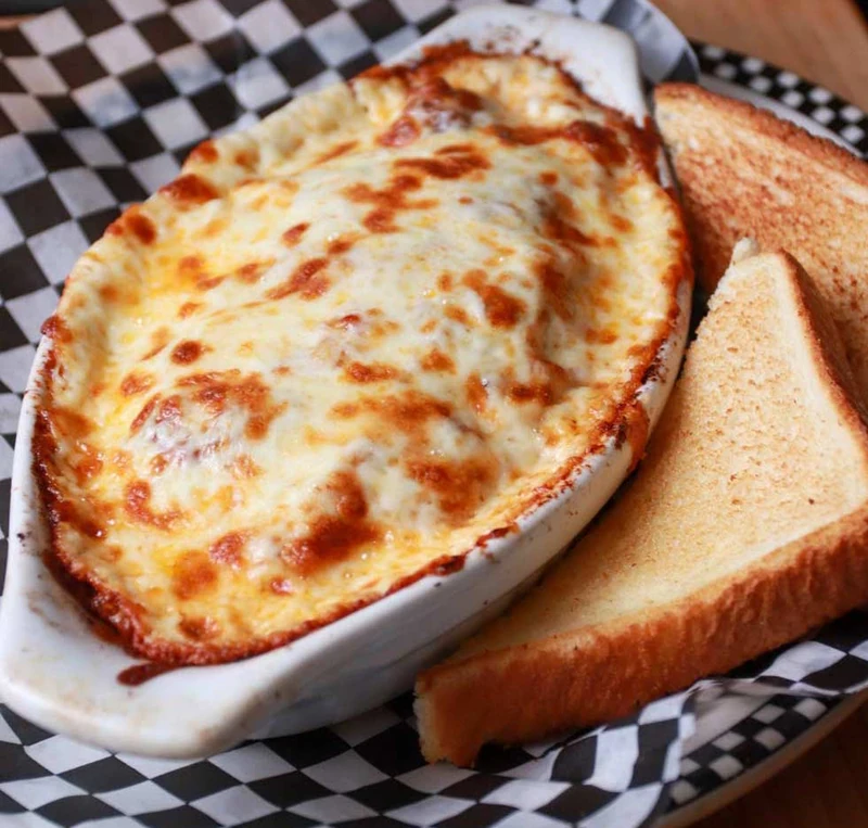 Baked lasagna with meat sauce and melted cheese at Monty's Pizza in Edmonton, AB
