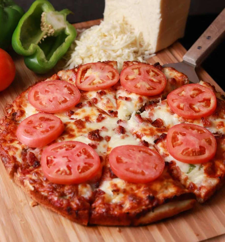 Monty Deluxe pizza with meats and fresh vegetables at Monty's Pizza in Edmonton, AB